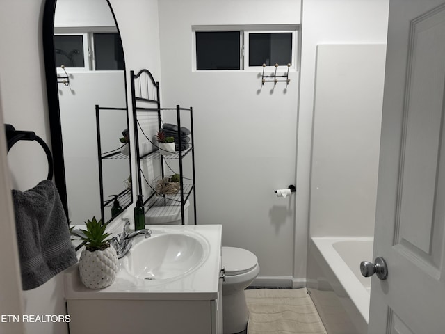 bathroom featuring vanity, toilet, and a bathtub