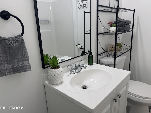 bathroom featuring vanity and toilet