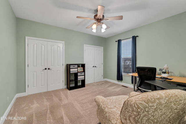 carpeted office with ceiling fan