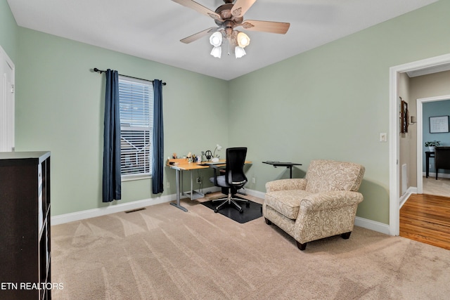 carpeted office with ceiling fan