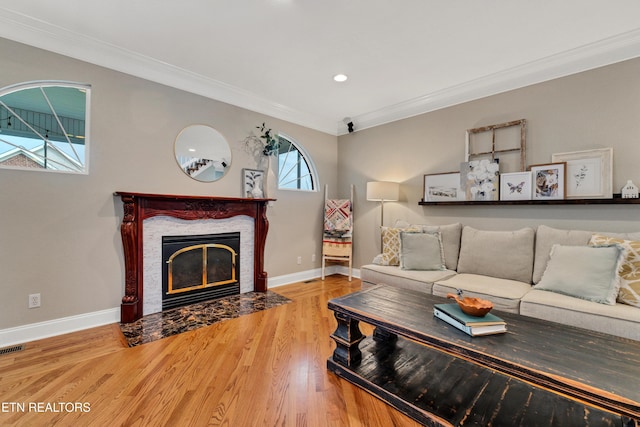 living room with wood-type flooring and ornamental molding