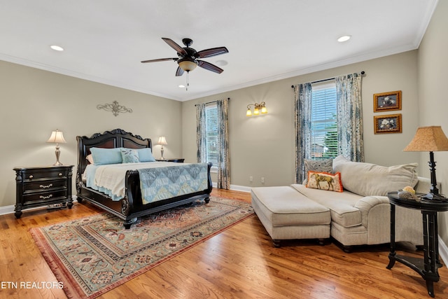 bedroom featuring hardwood / wood-style floors, crown molding, and ceiling fan