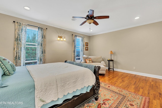 bedroom with hardwood / wood-style flooring, ornamental molding, and ceiling fan