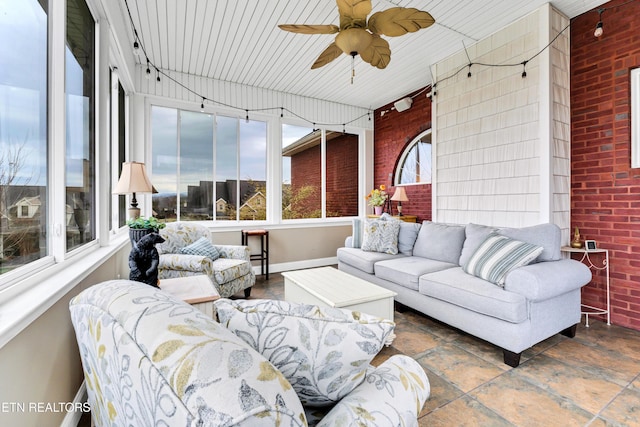 sunroom with rail lighting and ceiling fan