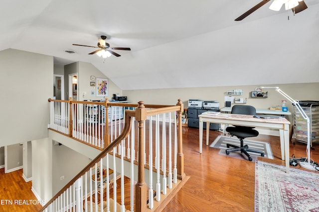 home office with vaulted ceiling, ceiling fan, and hardwood / wood-style floors