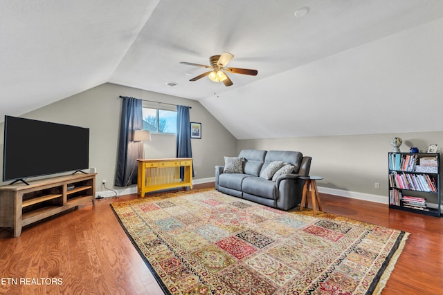 living room with lofted ceiling, hardwood / wood-style floors, and ceiling fan