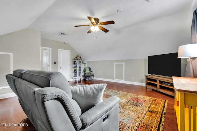 living room featuring dark hardwood / wood-style flooring, vaulted ceiling, and ceiling fan