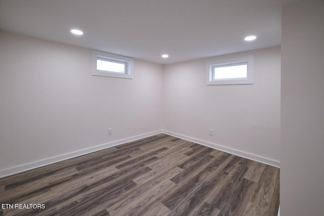 basement with dark hardwood / wood-style flooring