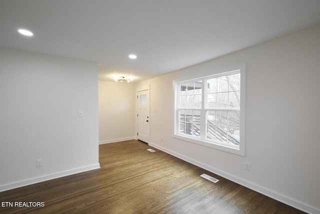 empty room featuring wood-type flooring