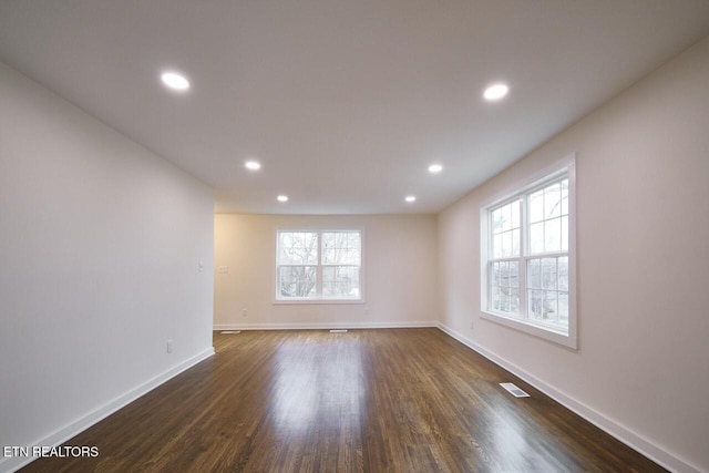 empty room with dark hardwood / wood-style floors