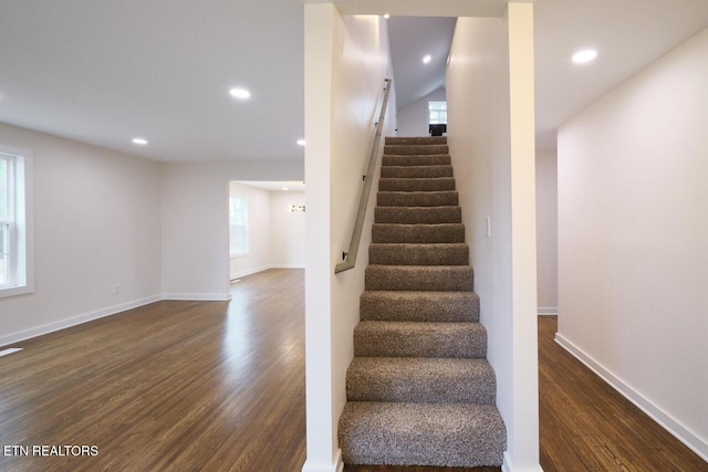 stairs featuring hardwood / wood-style floors