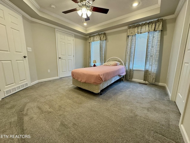 bedroom featuring baseboards, carpet, visible vents, and a tray ceiling