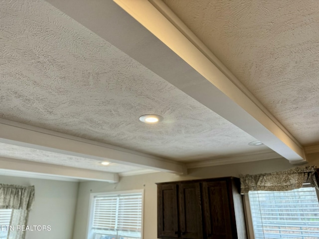 room details featuring recessed lighting, beam ceiling, and a textured ceiling