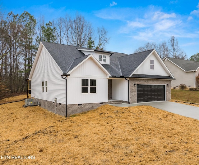 modern farmhouse style home with a garage, central AC unit, and a front yard