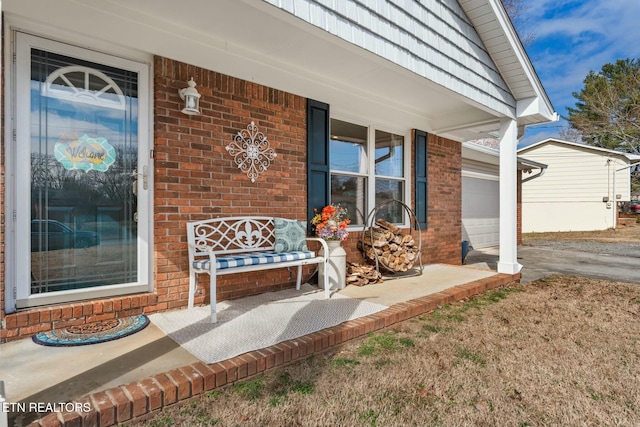 entrance to property featuring a garage and covered porch