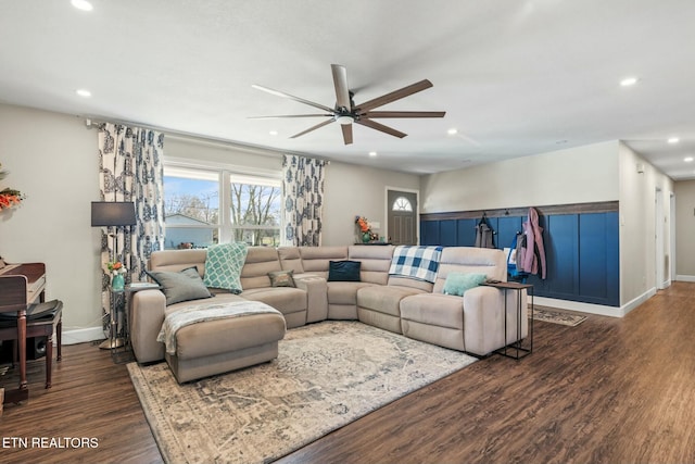 living room featuring dark wood-type flooring and ceiling fan