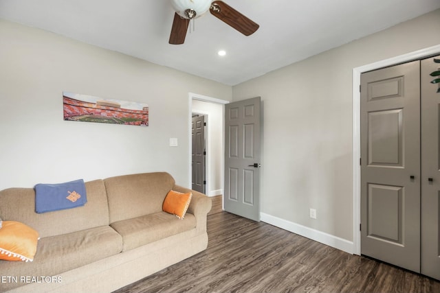 living room featuring dark hardwood / wood-style flooring and ceiling fan