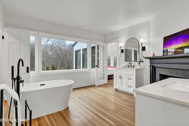 bathroom featuring vanity, a bath, and hardwood / wood-style floors