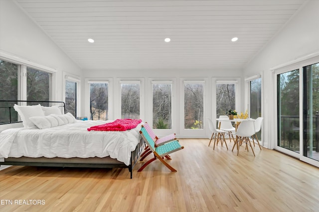 bedroom featuring lofted ceiling, access to outside, and light hardwood / wood-style flooring