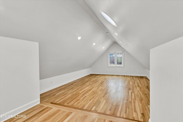 bonus room with vaulted ceiling and hardwood / wood-style floors