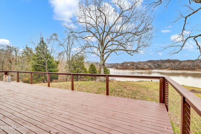 wooden terrace featuring a water view