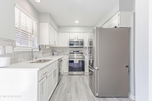 kitchen featuring white cabinetry, appliances with stainless steel finishes, and sink