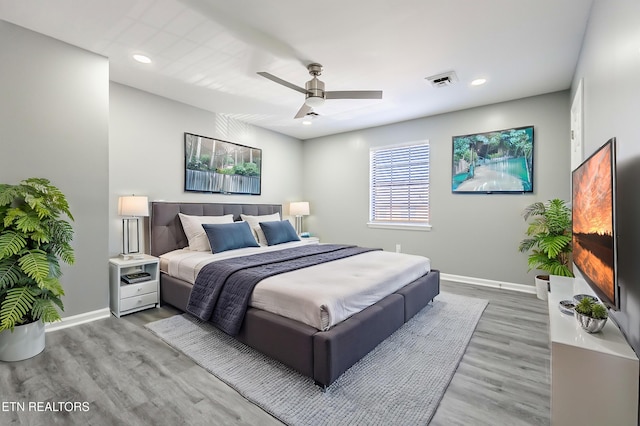 bedroom with wood-type flooring and ceiling fan