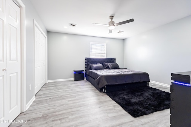 bedroom with light hardwood / wood-style floors and ceiling fan