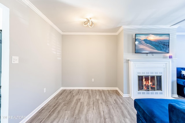 unfurnished living room with ornamental molding and light hardwood / wood-style floors