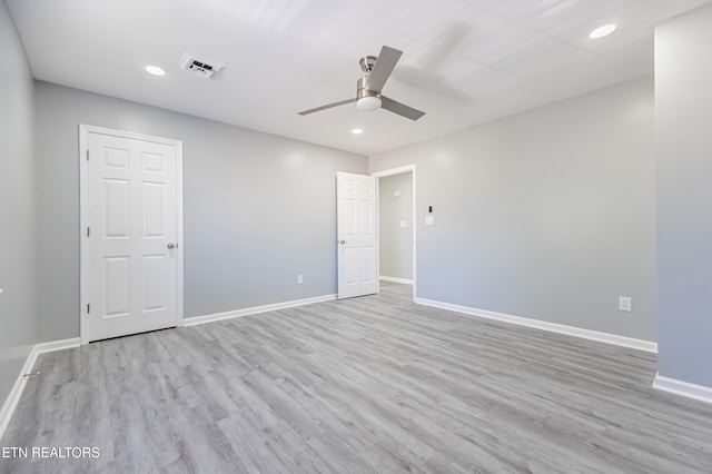 empty room with light hardwood / wood-style flooring and ceiling fan