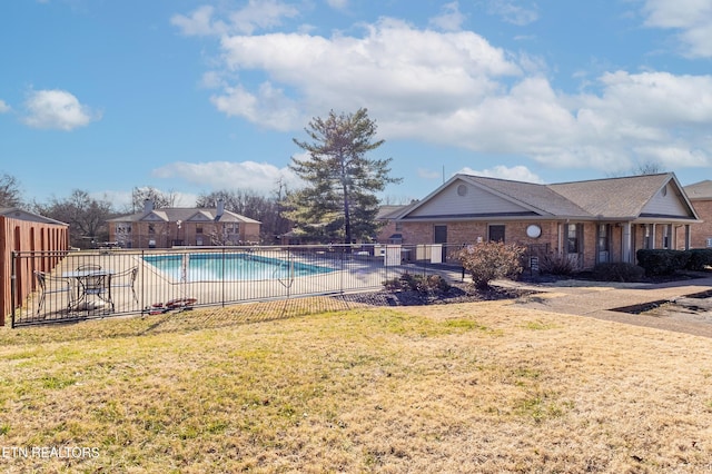 view of pool featuring a lawn and a patio area