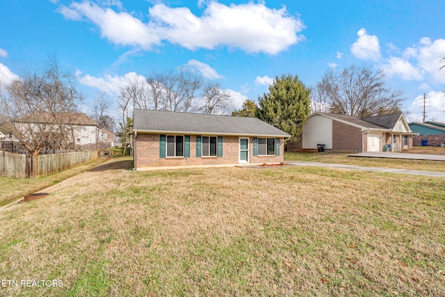 single story home featuring a garage and a front lawn