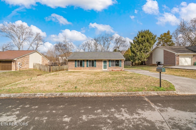 single story home featuring a garage and a front lawn