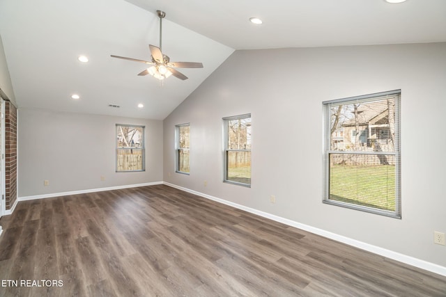 spare room with vaulted ceiling, dark hardwood / wood-style floors, and ceiling fan