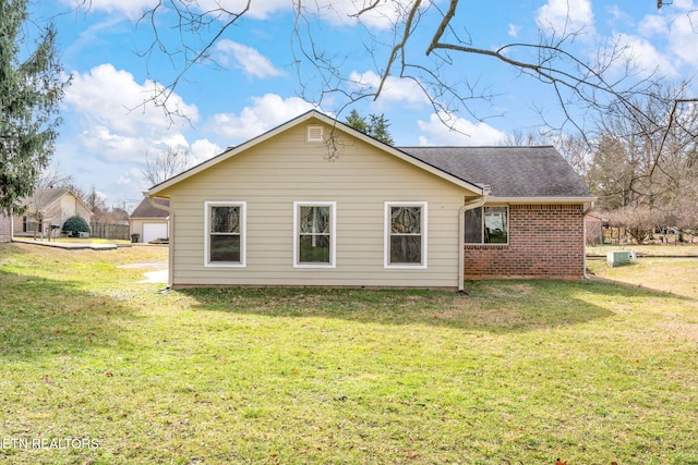 back of house with a lawn