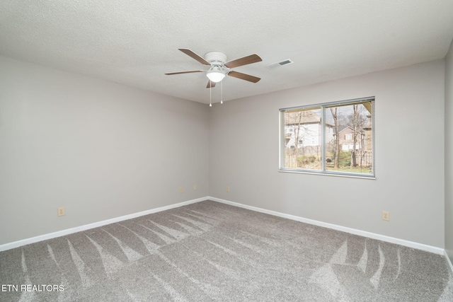 spare room with ceiling fan, a textured ceiling, and carpet flooring