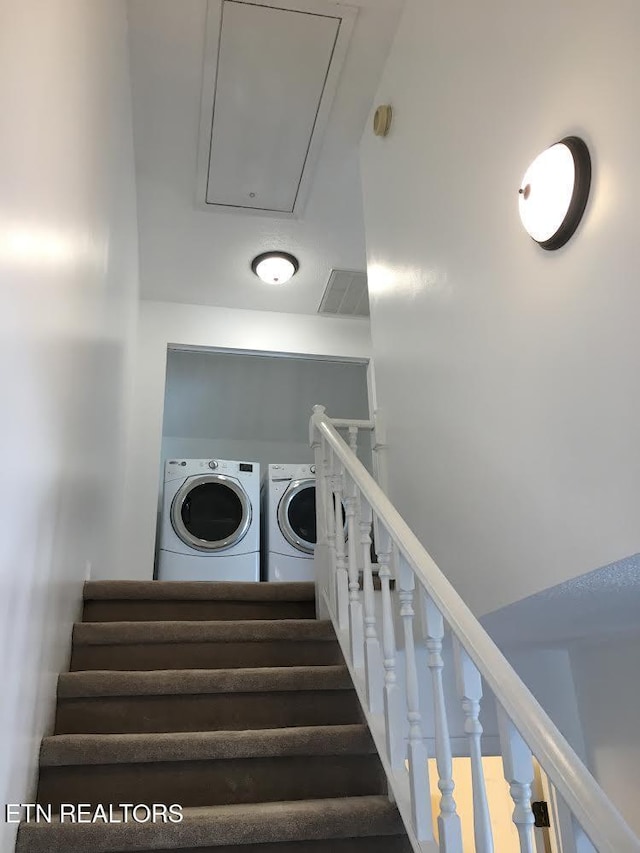 staircase featuring washer and clothes dryer