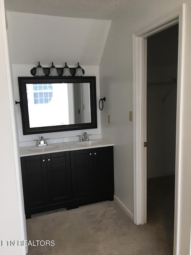 bathroom with vanity, vaulted ceiling, and concrete floors