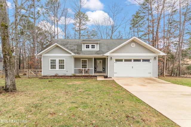 view of front facade featuring a garage, a front yard, and a porch