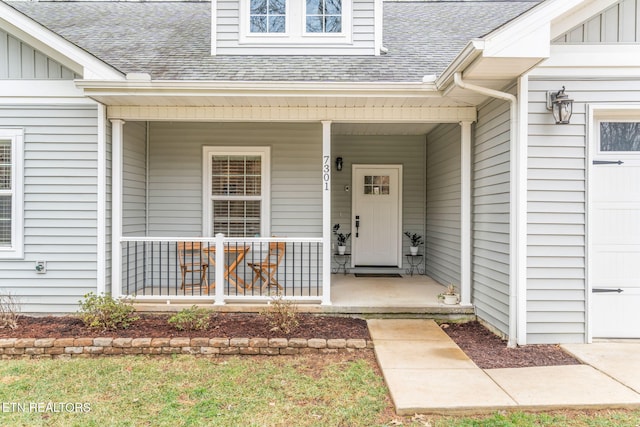 view of exterior entry featuring covered porch