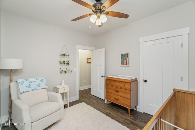 living area with ceiling fan and dark hardwood / wood-style flooring