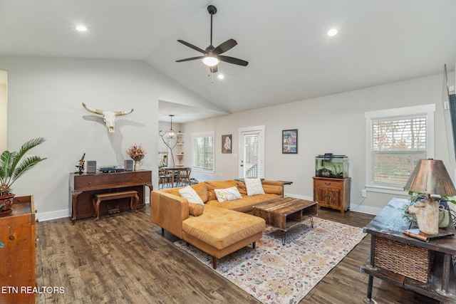 living room featuring dark wood-type flooring, ceiling fan, and vaulted ceiling