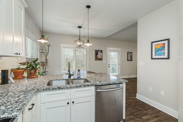 kitchen with dishwasher, light stone countertops, sink, and white cabinets