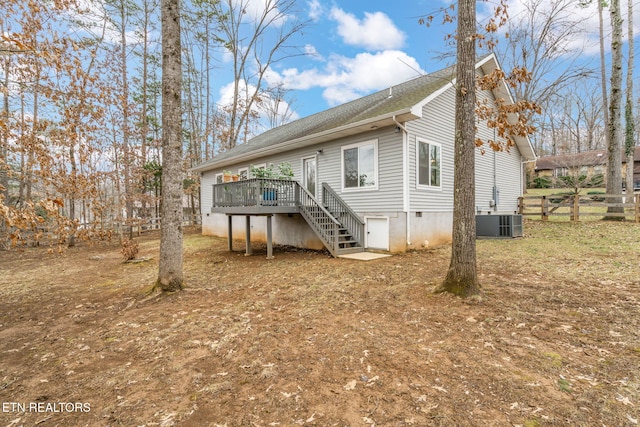 rear view of house featuring cooling unit and a deck