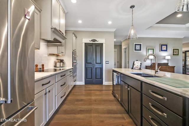 kitchen with sink, white cabinetry, hanging light fixtures, stainless steel appliances, and light stone countertops