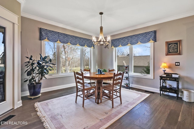 dining space featuring an inviting chandelier, ornamental molding, and dark hardwood / wood-style floors