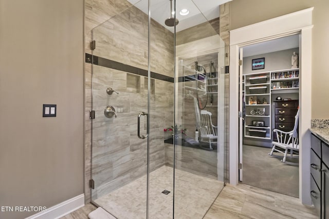 bathroom with walk in shower and vanity