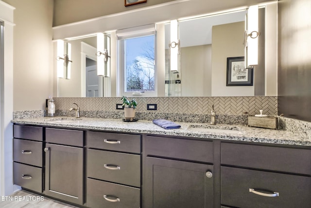 bathroom with tasteful backsplash and vanity