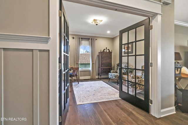 doorway to outside with ornamental molding and dark hardwood / wood-style floors