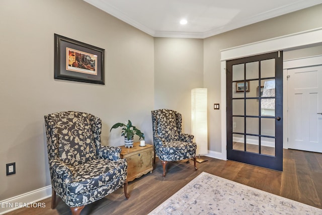 sitting room featuring hardwood / wood-style flooring and crown molding